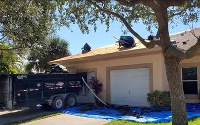 roofer inspecting a damaged roof in Port St Lucie, Florida